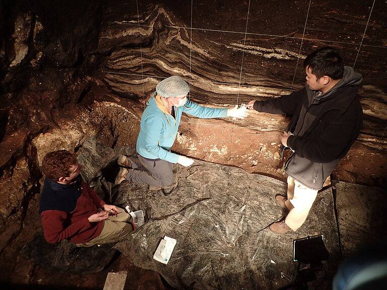 Zenobia Jacobs, Bo Li and Kieran O'Gorman collecting sediment samples in the South Chamber