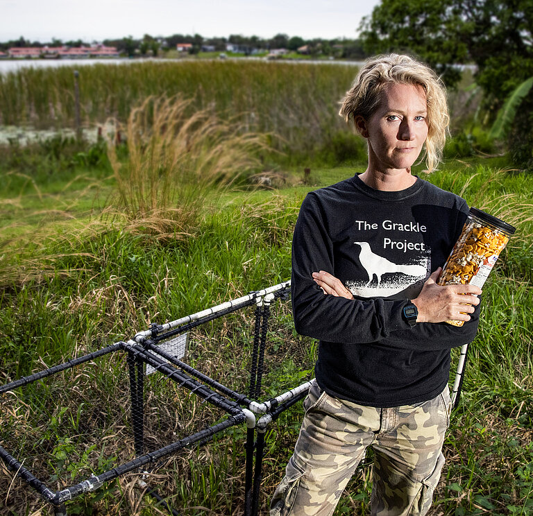 Corina with her grackle trap and trapping food in Florida