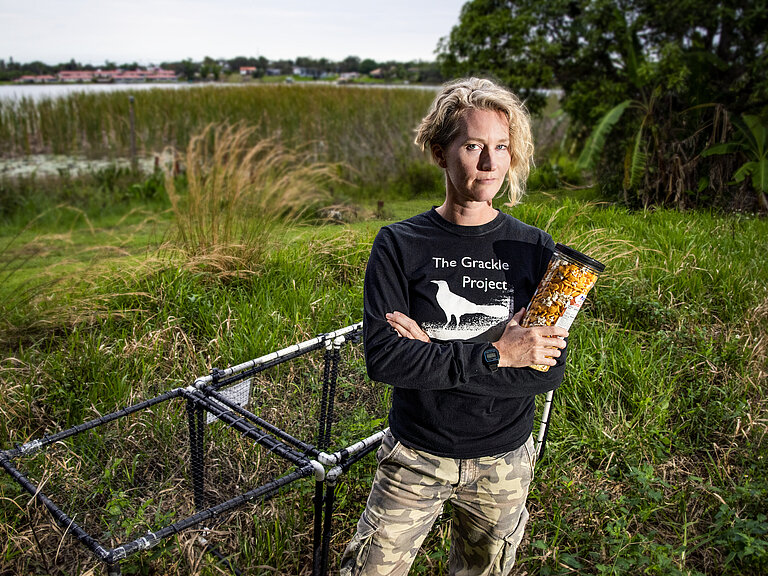 Corina with her grackle trap and trapping food in Florida